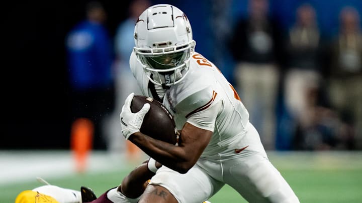 Texas Longhorns wide receiver Matthew Golden (2) evades a tackle from Arizona State Sun Devils defensive back Shamari Simmons (7) in the fourth quarter as the Texas Longhorns play the Arizona State Sun Devils in the Peach Bowl College Football Playoff quarterfinal at Mercedes-Benz Stadium in Atlanta, Georgia, Jan. 1, 2025. Texas Longhorns wide receiver Matthew Golden (2) evades a tackle from Arizona State Sun Devils defensive back Shamari Simmons (7) in the fourth quarter as the Texas Longhorns play the Arizona State Sun Devils in the Peach Bowl College Football Playoff quarterfinal at Mercedes-Benz Stadium in Atlanta, Georgia, Jan. 1, 2025.