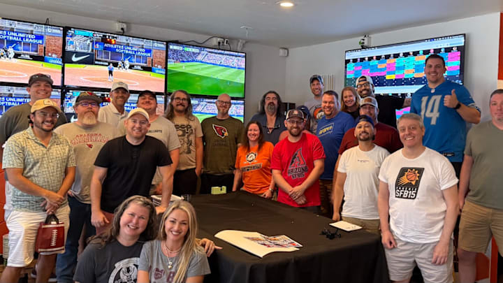 A group of friends gather together for a fantasy football draft. A group of friends gather together for a fantasy football draft.