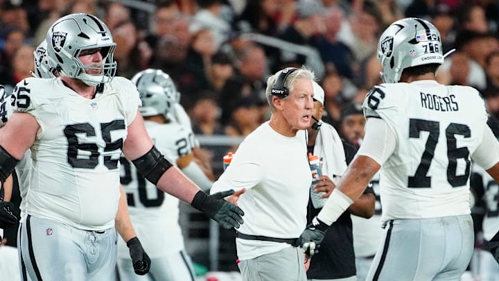 Raiders head coach Pete Carroll high-fives his team during a preseason game against the Cardinals at State Farm Stadium in Glendale on Aug. 23, 2025.