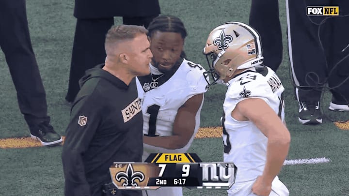 Alvin Kamara steps in between Saints interim head coach Darren Rizzi and punter Matthew Hayball 