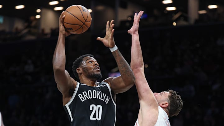 Jan 1, 2026; Brooklyn, New York, USA; Brooklyn Nets center Day'Ron Sharpe (20) shoots the ball as Houston Rockets center Alperen Sengun (28) defends during the first half at Barclays Center. Mandatory Credit: Vincent Carchietta-Imagn Images