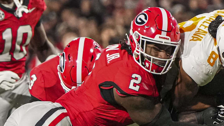 Nov 16, 2024; Athens, Georgia, USA; Tennessee Volunteers quarterback Nico Iamaleava (8) is tackled by Georgia Bulldogs linebacker Smael Mondon Jr. (2) during the first quarter at Sanford Stadium. Mandatory Credit: Dale Zanine-Imagn Images