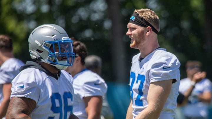 Detroit Lions defensive lineman Aidan Hutchinson (97) slaps hands with Kyle Peko (96) Detroit Lions defensive lineman Aidan Hutchinson (97) slaps hands with Kyle Peko (96)