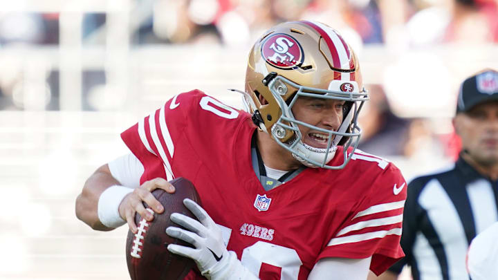Aug 9, 2025; Santa Clara, California, USA;  San Francisco 49ers quarterback Mac Jones (10) scrambles away from Denver Broncos outside linebacker Nik Bonitto (15) in the first quarter at Levi's Stadium. 