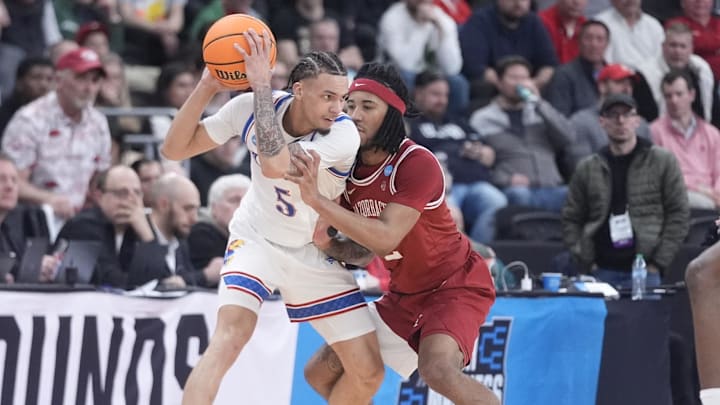 Mar 20, 2025; Providence, RI, USA;  Kansas Jayhawks guard Zeke Mayo (5) controls the ball against Arkansas Razorbacks guard Boogie Fland (2) during the second half at Amica Mutual Pavilion. Mandatory Credit: Gregory Fisher-Imagn Images