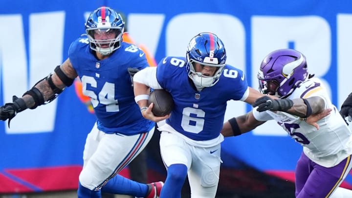 Dec 21, 2025; East Rutherford, New Jersey, USA; Minnesota Vikings linebacker Dallas Turner (15) tackles New York Giants quarterback Jaxson Dart (6) during the first half at MetLife Stadium.  