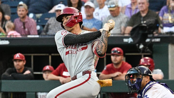 Jun 18, 2025; Omaha, Neb, USA;  Arkansas Razorbacks shortstop Wehiwa Aloy (9) singles against the LSU Tigers during the eighth inning at Charles Schwab Field. Mandatory Credit: Steven Branscombe-Imagn Images