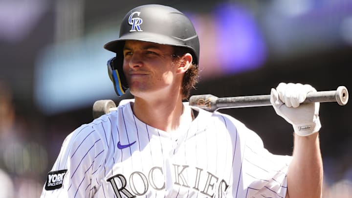 Aug 3, 2025; Denver, Colorado, USA; Colorado Rockies center fielder Mickey Moniak (22) on deck in the first inning against the Pittsburgh Pirates at Coors Field. Mandatory Credit: Ron Chenoy-Imagn Images