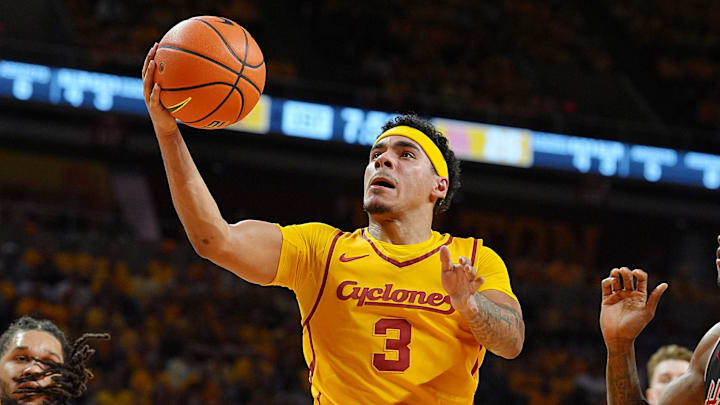 Iowa State Cyclones guard Tamin Lipsey (3) goes for a layup around Houston Cougars forward Joseph Tugler (11) during the first half in the3 Big-12 men’s basketball at Hilton Coliseum on Feb. 16, 2026, in Ames, Iowa