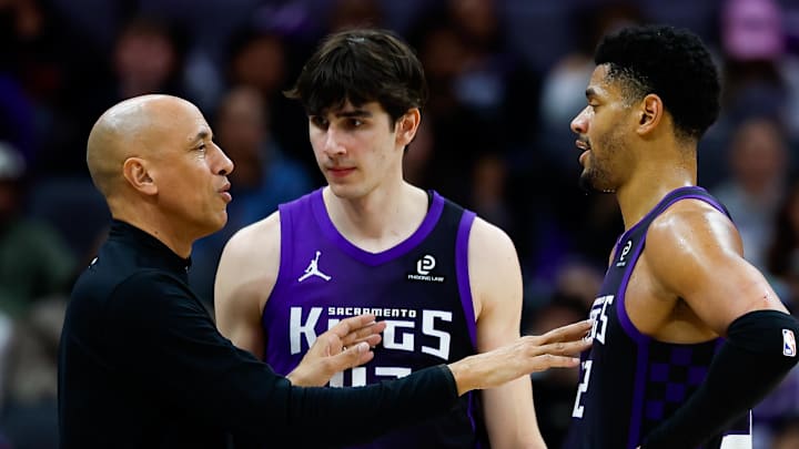 Feb 6, 2026; Sacramento, California, USA; Sacramento Kings head coach Doug Christie talks with center Dylan Cardwell (32) and center Maxime Raynaud (42) during the fourth quarter against the Los Angeles Clippers at Golden 1 Center.