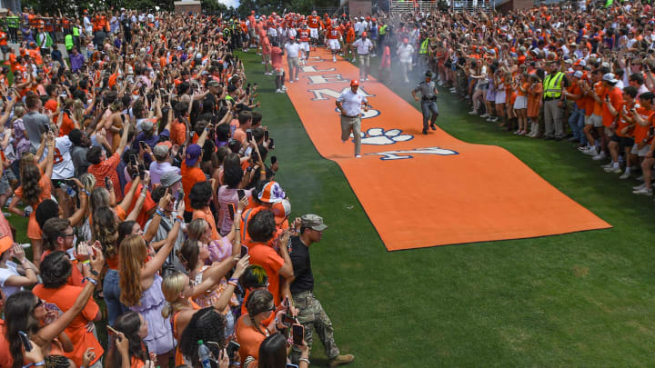 Sep 9, 2023; Clemson, South Carolina, USA; Clemson head coach Dabo Swinney runs down the hill after rubbing Howard's Rock before the game with Charleston Southern at Memorial Stadium.