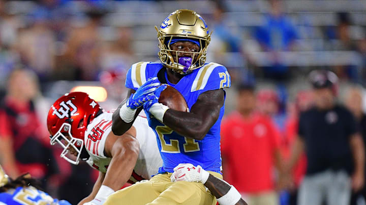 Aug 30, 2025; Pasadena, California, USA; UCLA Bruins defensive back Cole Martin (21) is brought down by Utah Utes cornerback Jason Stokes Jr. (13) during the second half at Rose Bowl. Mandatory Credit: Gary A. Vasquez-Imagn Images