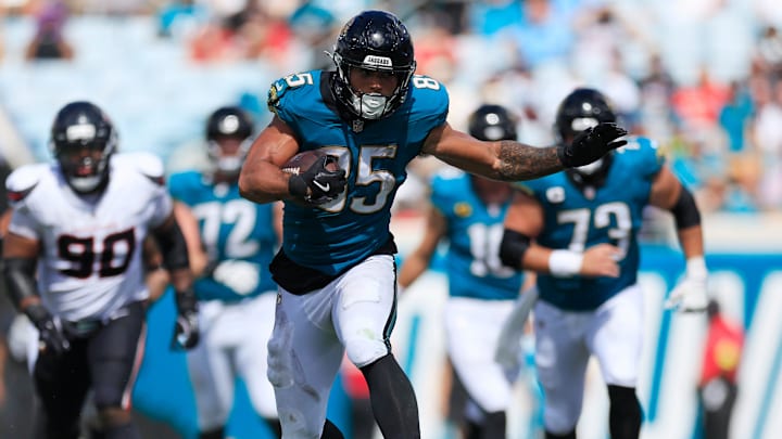 Jacksonville Jaguars tight end Brenton Strange (85) rushes for yards, leaping past Houston Texans safety Jalen Pitre (5) during the third quarter of an NFL football matchup at EverBank Stadium, Sunday, Sept. 21, 2025, in Jacksonville, Fla. The Jaguars defeated the Texans 17-10.