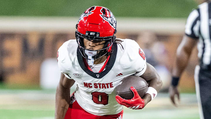 Sep 11, 2025; Winston-Salem, North Carolina, USA;  North Carolina State Wolfpack wide receiver Keenan Jackson (8) runs past Wake Forest Demon Deacons defensive back Nick Andersen (45) in the second half at Allegacy Federal Credit Union Stadium. Mandatory Credit: Luke Jamroz-Imagn Images