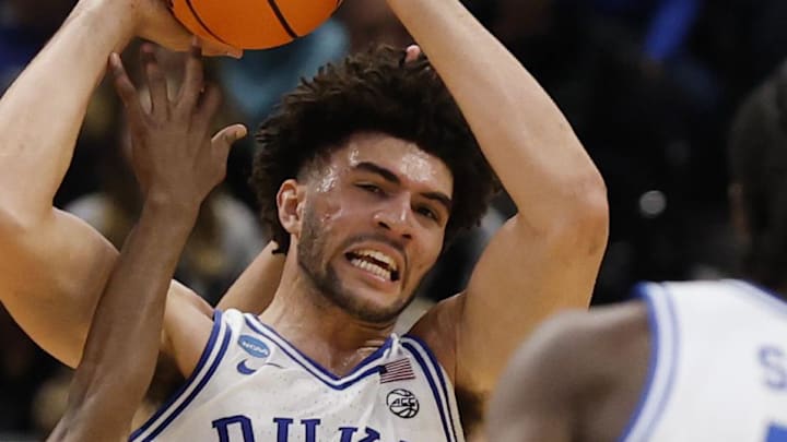 Mar 29, 2026; Washington, DC, USA; Duke Blue Devils forward Cameron Boozer (12) holds the ball as UConn Huskies guard Malachi Smith (0) defends during an Elite Eight game of the East Regional of the men's 2026 NCAA Tournament at Capital One Arena. Mandatory Credit: Geoff Burke-Imagn Images