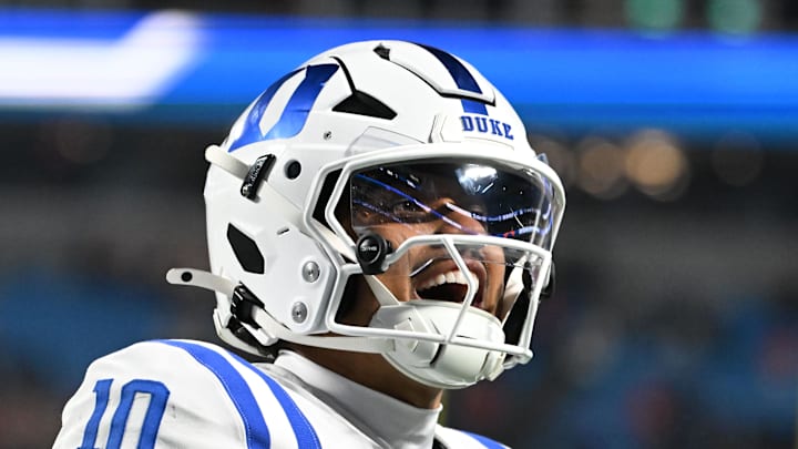 Dec 6, 2025; Charlotte, NC, USA; Duke Blue Devils quarterback Darian Mensah (10) celebrates after the Blue Devils score a touchdown in overtime during the  ACC Championship game at Bank of America Stadium. Mandatory Credit: Bob Donnan-Imagn Images