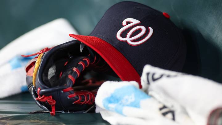 Dark blue Washington Nationals hat on top of a black mitt Dark blue Washington Nationals hat on top of a black mitt