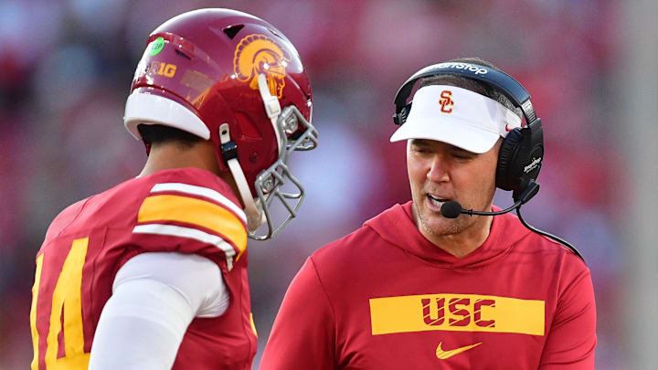 Nov 16, 2024; Los Angeles, California, USA; Southern California Trojans head coach Lincoln Riley greets quarterback Jayden Maiava (14) after scoring a touchdown against the Nebraska Cornhuskers during the second half at the Los Angeles Memorial Coliseum. Nov 16, 2024; Los Angeles, California, USA; Southern California Trojans head coach Lincoln Riley greets quarterback Jayden Maiava (14) after scoring a touchdown against the Nebraska Cornhuskers during the second half at the Los Angeles Memorial Coliseum.
