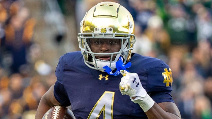 Nov 22, 2025; South Bend, Indiana, USA; Notre Dame Fighting Irish running back Jeremiyah Love (4) runs the ball against the Syracuse Orange during the first half at Notre Dame Stadium. Nov 22, 2025; South Bend, Indiana, USA; Notre Dame Fighting Irish running back Jeremiyah Love (4) runs the ball against the Syracuse Orange during the first half at Notre Dame Stadium.