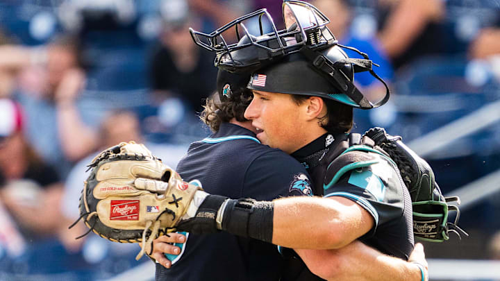 Jun 18, 2025; Omaha, Neb, USA; Coastal Carolina Chanticleers pitcher Dominick Carbone (40) and catcher Caden Bodine (17) embrace after defeating the Louisville Cardinals at Charles Schwab Field. 