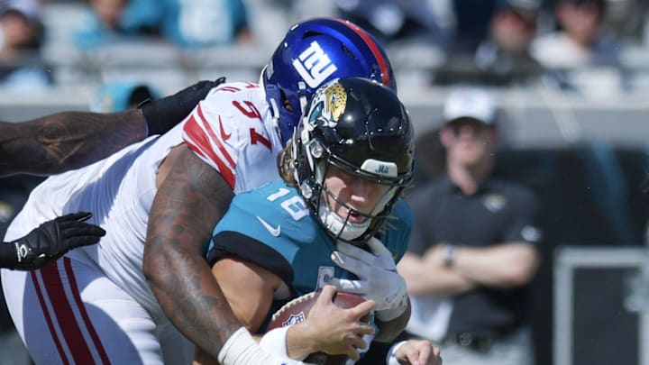 Jacksonville Jaguars quarterback Trevor Lawrence (16) is brought down by New York Giants defensive tackle Dexter Lawrence (97) on a one yard scramble late in the first quarter. The Jacksonville Jaguars hosted the New York Giants at TIAA Bank Field in Jacksonville, FL Sunday, October 23, 2022. The Jaguars trailed at the half 11 to 13. [Bob Self/Florida Times-Union]

Jki 102322 Hsfb Bs Jaguars 22