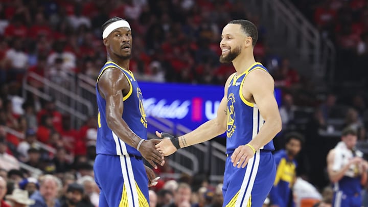 Golden State Warriors guard Stephen Curry (30) celebrates with forward Jimmy Butler III (10) after a play during the second quarter against the Houston Rockets at Toyota Center.