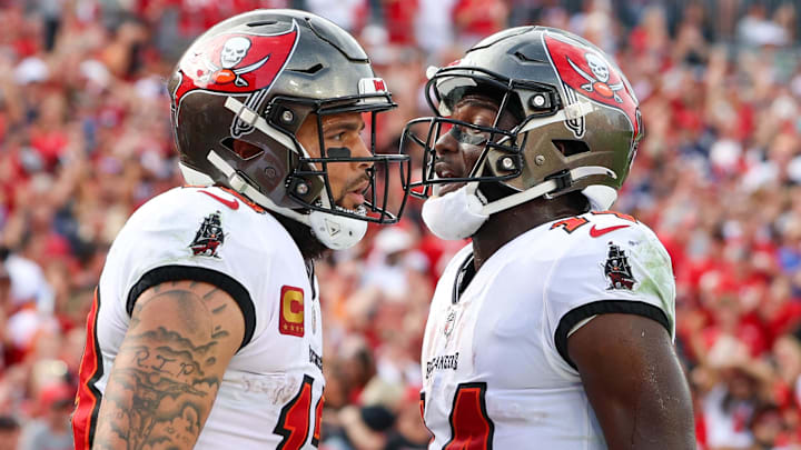 Jan 1, 2023; Tampa, Florida, USA;  Tampa Bay Buccaneers wide receiver Chris Godwin (14) congratulates wide receiver Mike Evans (13) after scoring a touchdown against the Carolina Panthers in the fourth quarter at Raymond James Stadium. Mandatory Credit: Nathan Ray Seebeck-Imagn Images