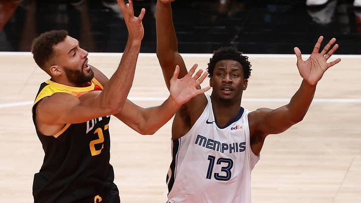 Jun 2, 2021; Salt Lake City, Utah, USA; Utah Jazz center Rudy Gobert (27) shoots the ball past Memphis Grizzlies forward Jaren Jackson Jr. (13) during the fourth quarter in game five of the first round of the 2021 NBA Playoffs at Vivint Arena. Utah Jazz win 126-110 and advance to the second round. Mandatory Credit: Chris Nicoll-USA TODAY Sports Jun 2, 2021; Salt Lake City, Utah, USA; Utah Jazz center Rudy Gobert (27) shoots the ball past Memphis Grizzlies forward Jaren Jackson Jr. (13) during the fourth quarter in game five of the first round of the 2021 NBA Playoffs at Vivint Arena. Utah Jazz win 126-110 and advance to the second round. Mandatory Credit: Chris Nicoll-USA TODAY Sports