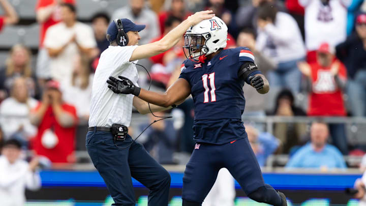 Nov 22, 2025; Tucson, Arizona, USA; Arizona Wildcats head coach Brent Brennan celebrates an interception with linebacker Jabari Mann (11) against the Baylor Bears in the second half at Casino Del Sol Stadium. Mandatory Credit: Mark J. Rebilas-Imagn Images