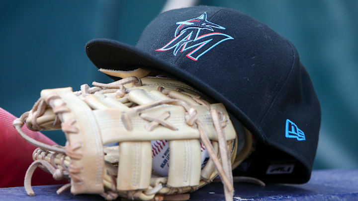 Apr 24, 2024; Atlanta, Georgia, USA; A detailed view of a Miami Marlins hat and glove in the dugout before a game against the Atlanta Braves at Truist Park. Mandatory Credit: Brett Davis-Imagn Images