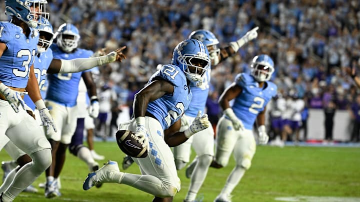 Sep 1, 2025; Chapel Hill, North Carolina, USA; North Carolina Tar Heels defensive back Kaleb Cost (21) reacts after intercepting a pass in the second quarter at Kenan Stadium. Mandatory Credit: Bob Donnan-Imagn Images