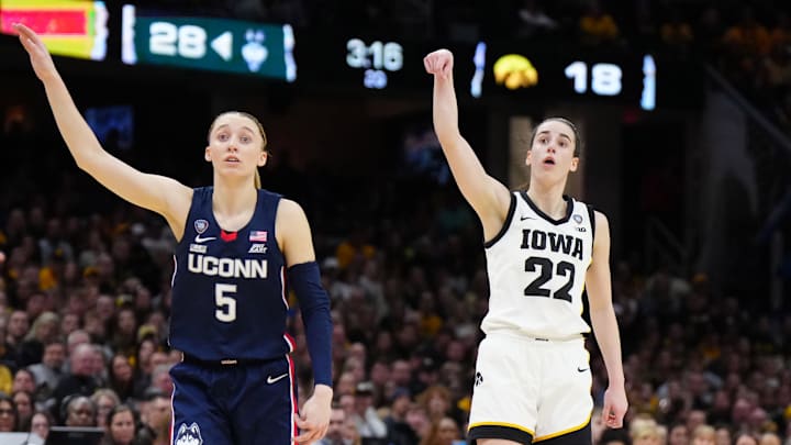 Apr 5, 2024; Cleveland, OH, USA; Iowa Hawkeyes guard Caitlin Clark (22) and Connecticut Huskies guard Paige Bueckers (5) react in the second quarter in the semifinals of the Final Four of the womens 2024 NCAA Tournament at Rocket Mortgage FieldHouse. Mandatory Credit: Kirby Lee-Imagn Images