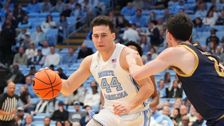 Jan 21, 2026; Chapel Hill, North Carolina, USA; North Carolina Tar Heels guard Luka Bogavac (44) with the ball as Notre Dame Fighting Irish guard Logan Imes (2) defends in the second half at Dean E. Smith Center. Mandatory Credit: Bob Donnan-Imagn Images