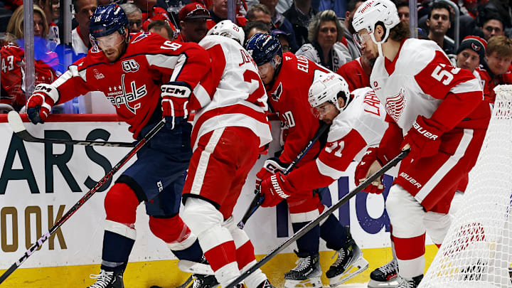 Mar 18, 2025; Washington, District of Columbia, USA; Washington Capitals right wing Taylor Raddysh (16) goes for the puck against Detroit Red Wings defenseman Albert Johansson (20) during the first period at Capital One Arena. Mandatory Credit: Peter Casey-Imagn Images