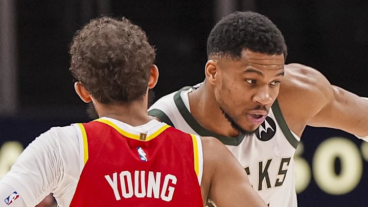 Mar 4, 2025; Atlanta, Georgia, USA; Milwaukee Bucks forward Giannis Antetokounmpo (34) reacts with Atlanta Hawks guard Trae Young (11) after the Bucks defeated the Hawks at State Farm Arena. Mandatory Credit: Dale Zanine-Imagn Images