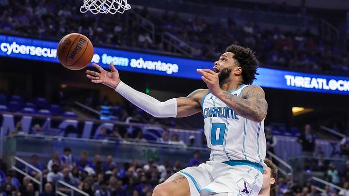 Charlotte Hornets forward Miles Bridges is fouled by Orlando Magic guard Desmond Bane during the second half during the play-in rounds of the 2026 NBA Playoffs at Kia Center.
