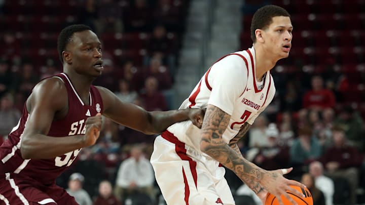 Arkansas Razorbacks forward Trevon Brazile (7) handles the ball as Mississippi State Bulldogs forward Achor Achor (99) defends during the first half at Humphrey Coliseum in Starkville, Miss.