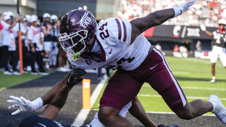 Cincinnati Bearcats wide receiver Braden Smith (0) and Eastern Kentucky Colonels defensive back Mike Smith Jr. (24) fall to the ground in an attempt to catch the ball in the end zone during the first half of the NCAA football game between the Cincinnati Bearcats and the Eastern Kentucky Colonels at Nippert Stadium. Cincinnati Bearcats wide receiver Braden Smith (0) and Eastern Kentucky Colonels defensive back Mike Smith Jr. (24) fall to the ground in an attempt to catch the ball in the end zone during the first half of the NCAA football game between the Cincinnati Bearcats and the Eastern Kentucky Colonels at Nippert Stadium.