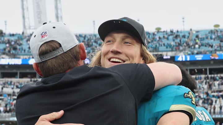 Jan 4, 2026; Jacksonville, Florida, USA; Jacksonville Jaguars quarterback Trevor Lawrence (16) celebrates with head coach Liam Coen (obscured) after the game against the Tennessee Titans at EverBank Stadium. 