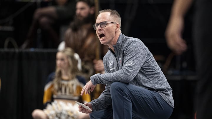 Mar 7, 2025; Kansas City, MO, USA; West Virginia Mountaineers head coach Mark Kellogg looks on from the sideline in the first quarter against the Kansas State Wildcats at T-Mobile Center.