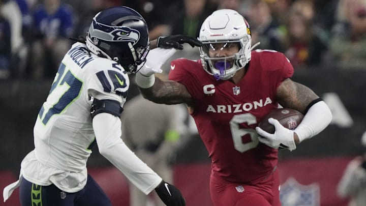 Arizona Cardinals running back James Conner (6) runs against Seattle Seahawks cornerback Riq Woolen (27) during the first quarter at State Farm Stadium in Glendale on Jan. 7, 2024. Arizona Cardinals running back James Conner (6) runs against Seattle Seahawks cornerback Riq Woolen (27) during the first quarter at State Farm Stadium in Glendale on Jan. 7, 2024.