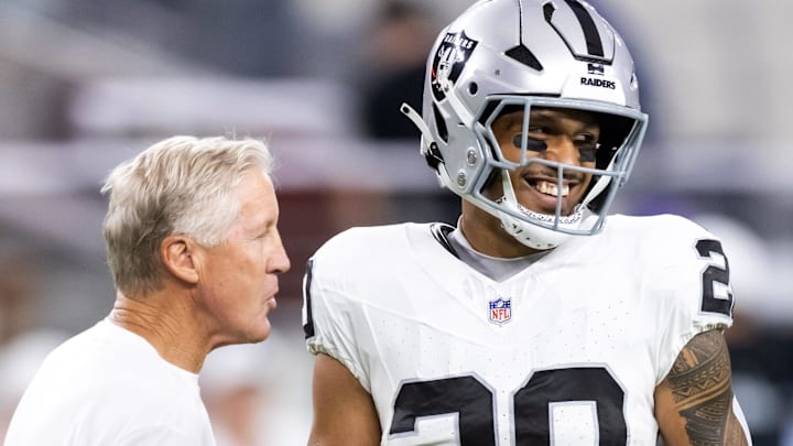 Aug 23, 2025; Glendale, Arizona, USA; Las Vegas Raiders head coach Pete Carroll with safety Isaiah Pola-Mao (20) against the Arizona Cardinals during a preseason NFL game at State Farm Stadium. Mandatory Credit: Mark J. Rebilas-Imagn Images