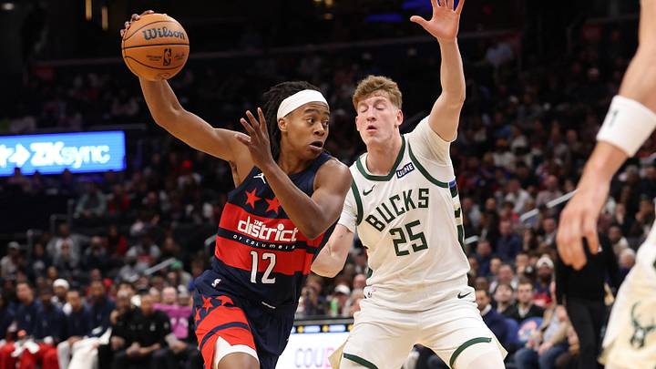 Oct 21, 2026; Washington, District of Columbia, USA; Washington Wizards guard Tre Johnson (12) drives to the basket as Milwaukee Bucks guard Kasparas Jakucionis (25) defends in the first half at Capital One Arena. Mandatory Credit: Geoff Burke-Imagn Images