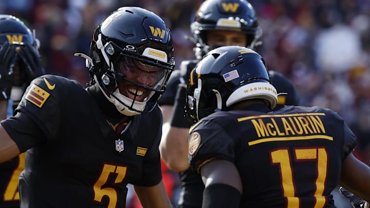 Dec 1, 2024; Landover, Maryland, USA; Washington Commanders wide receiver Terry McLaurin (17) and Commanders quarterback Jayden Daniels (5) celebrate after connecting on a touchdown pass against the Tennessee Titans during the first quarter at Northwest Stadium. Mandatory Credit: Geoff Burke-Imagn Images