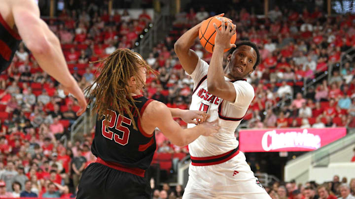 Mar 7, 2026; Raleigh, North Carolina, USA;  NC State Wolfpack guard Quadir Copeland (11) controls the ball around Stanford Cardinal guard Jeremy Dent-Smith (25) during the first half at Lenovo Center. Mandatory Credit: Zachary Taft-Imagn Images