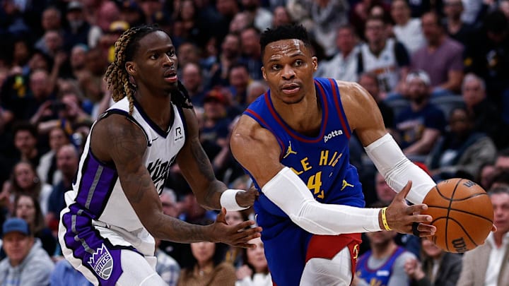 Mar 5, 2025; Denver, Colorado, USA; Denver Nuggets guard Russell Westbrook (4) controls the ball as Sacramento Kings guard Keon Ellis (23) guards in the fourth quarter at Ball Arena. Mandatory Credit: Isaiah J. Downing-Imagn Images