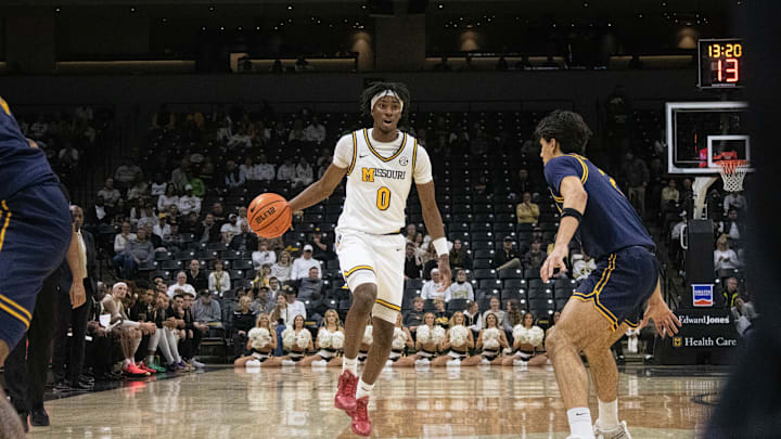 Dec. 3, 2024; Columbia, Missouri, USA; Missouri Tiger guard Anthony Robinson II (2) dribbles past California guard Andrej Stojakovic during the first half of a game at Mizzou Arena. 