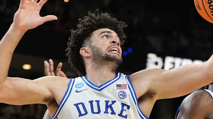 Mar 19, 2026; Greenville, SC, USA; Duke Blue Devils forward Cameron Boozer (12) grabs a rebound against the Siena Saints in the second half during a first round game of the men's 2026 NCAA Tournament at Bon Secours Wellness Arena. Mandatory Credit: Bob Donnan-Imagn Images