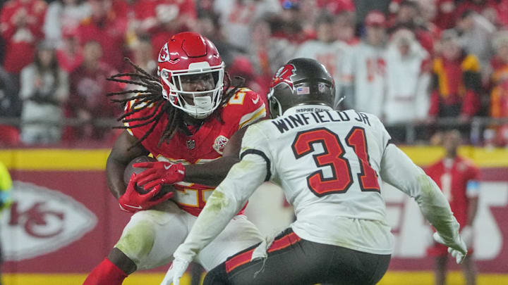 Nov 4, 2024; Kansas City, Missouri, USA; Kansas City Chiefs running back Kareem Hunt (29) runs the ball as Tampa Bay Buccaneers safety Antoine Winfield Jr. (31) defends during the game at GEHA Field at Arrowhead Stadium. Mandatory Credit: Denny Medley-Imagn Images