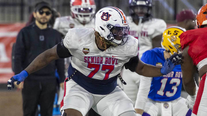 Jan 28, 2026; Mobile, AL, USA; American Team offensive lineman Jeremiah Wright (77) of Auburn blocks during American Senior Bowl practice at Hancock Whitney Stadium. Mandatory Credit: Vasha Hunt-Imagn Images